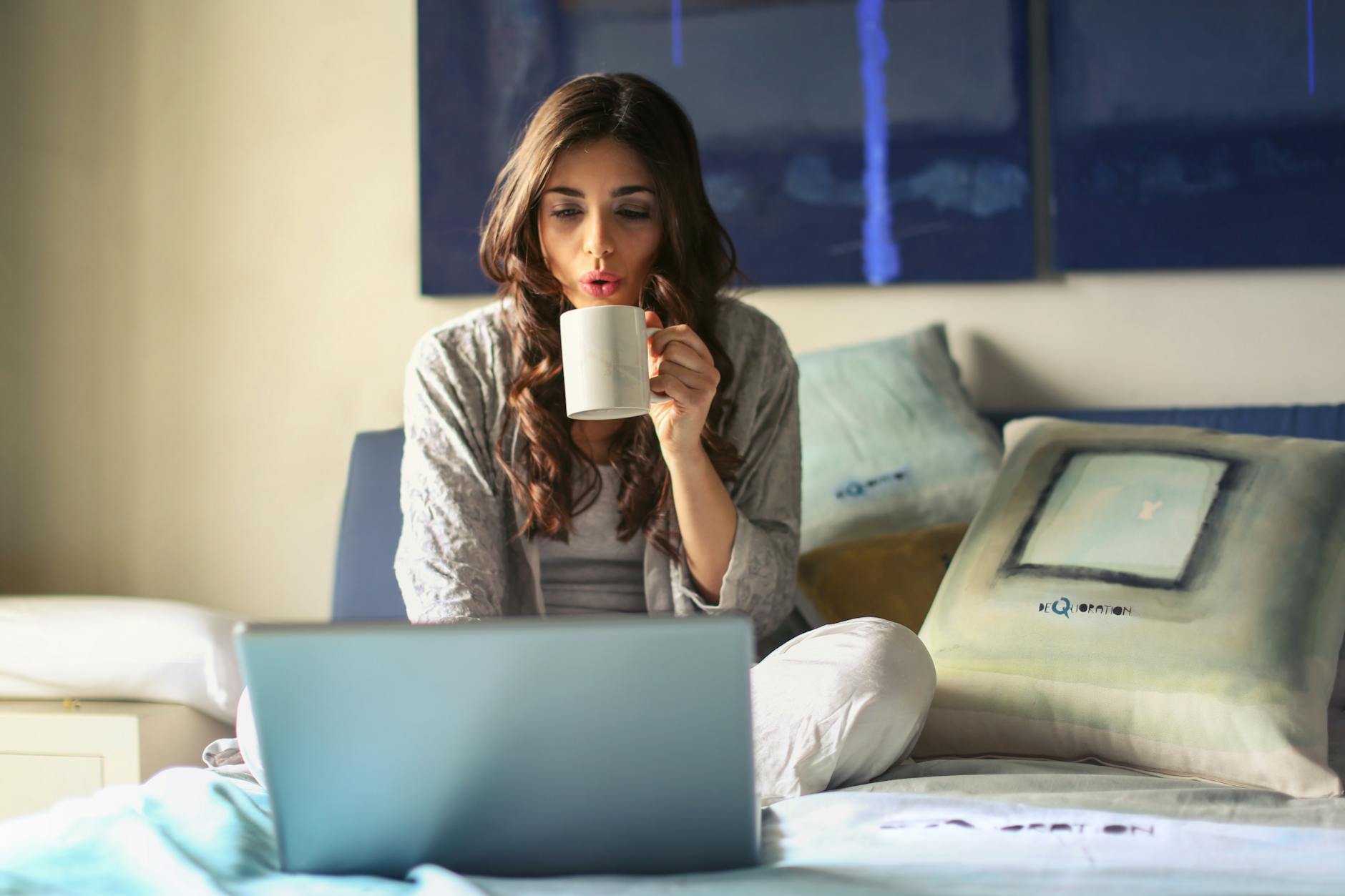 Laptop and coffee at home with a streaming subscription on screen