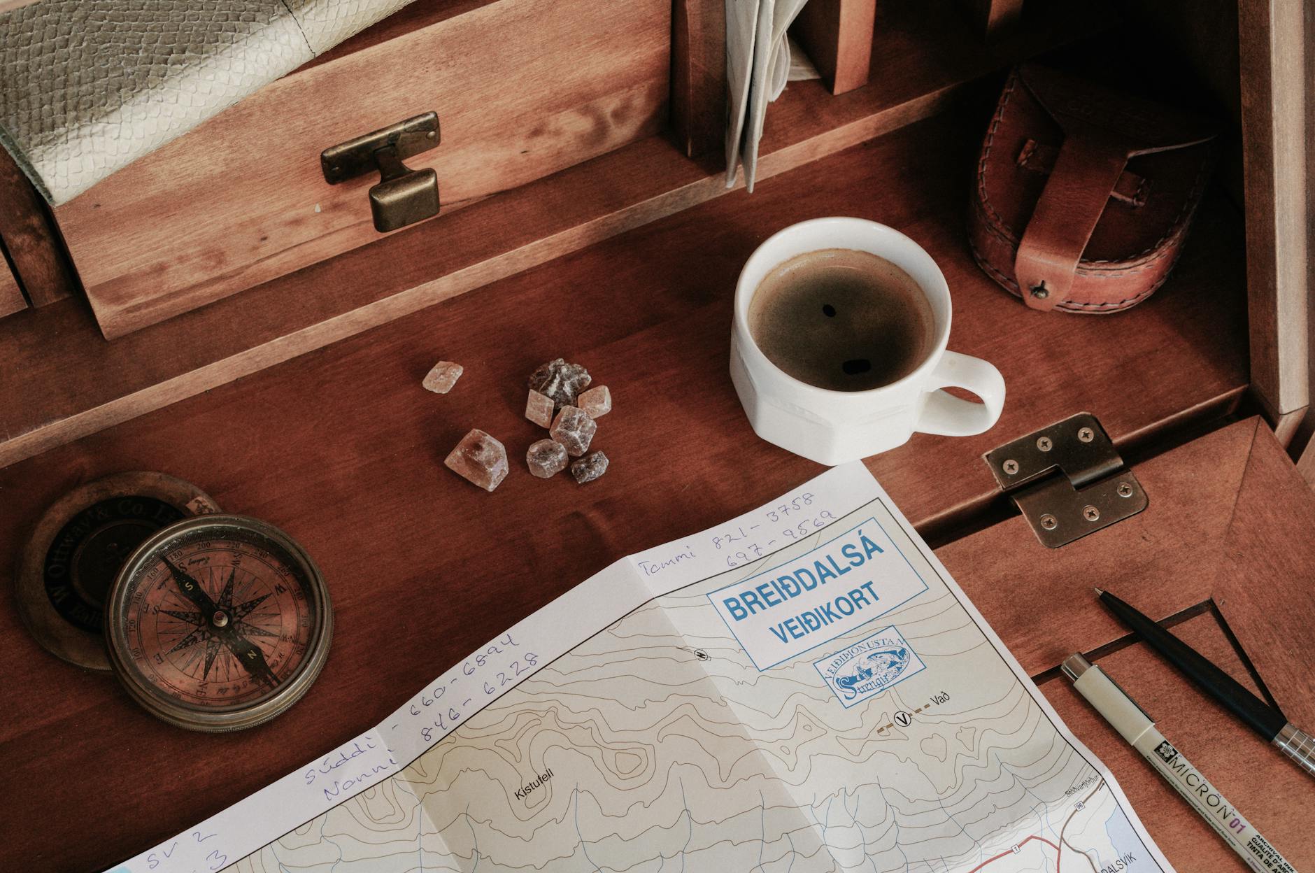 Travel-agent desk with holiday brochures and a world map