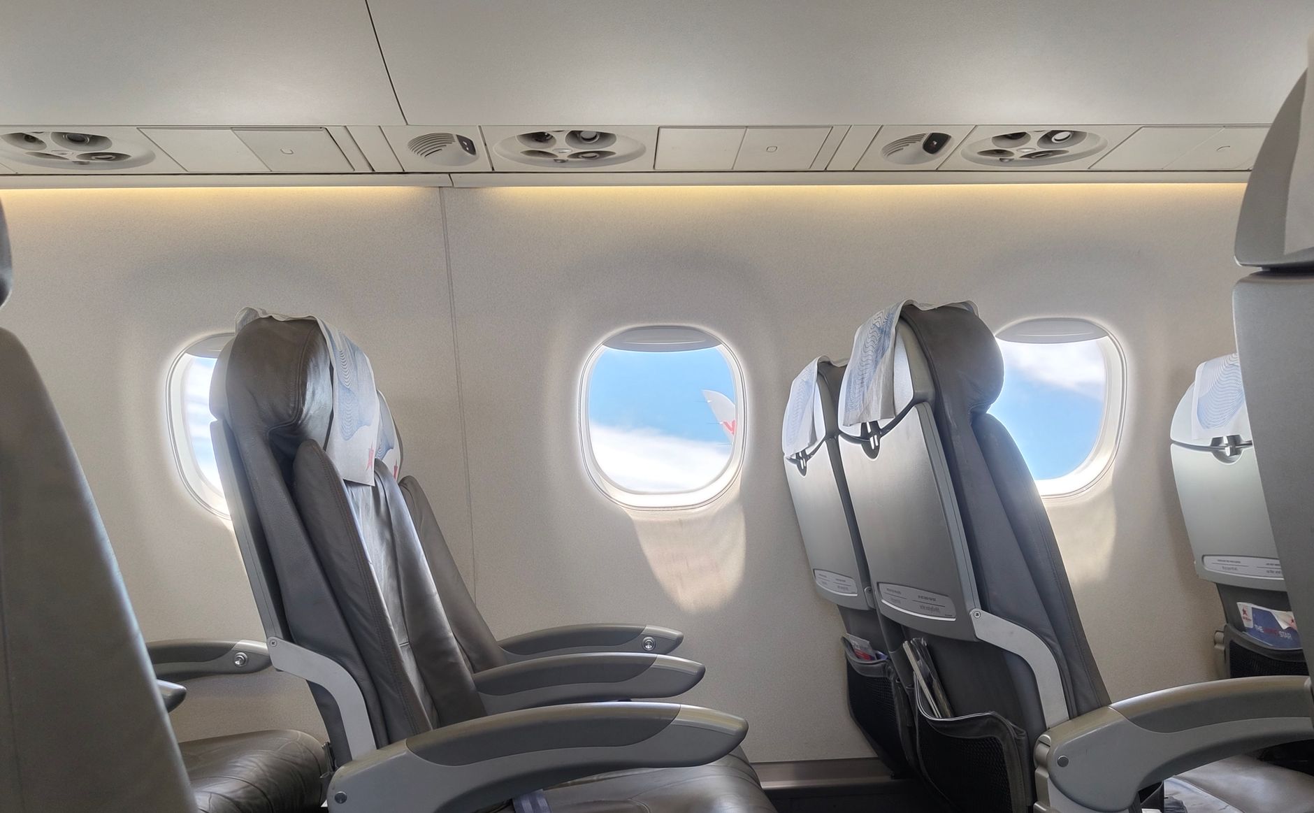 Business-class cabin window seat with dimmed mood lighting