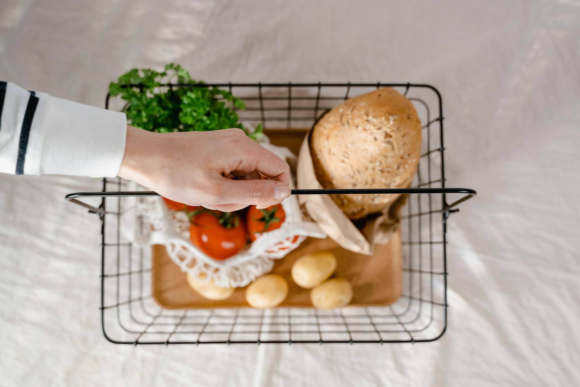 Grocery basket with bread and vegetables at a corner shop