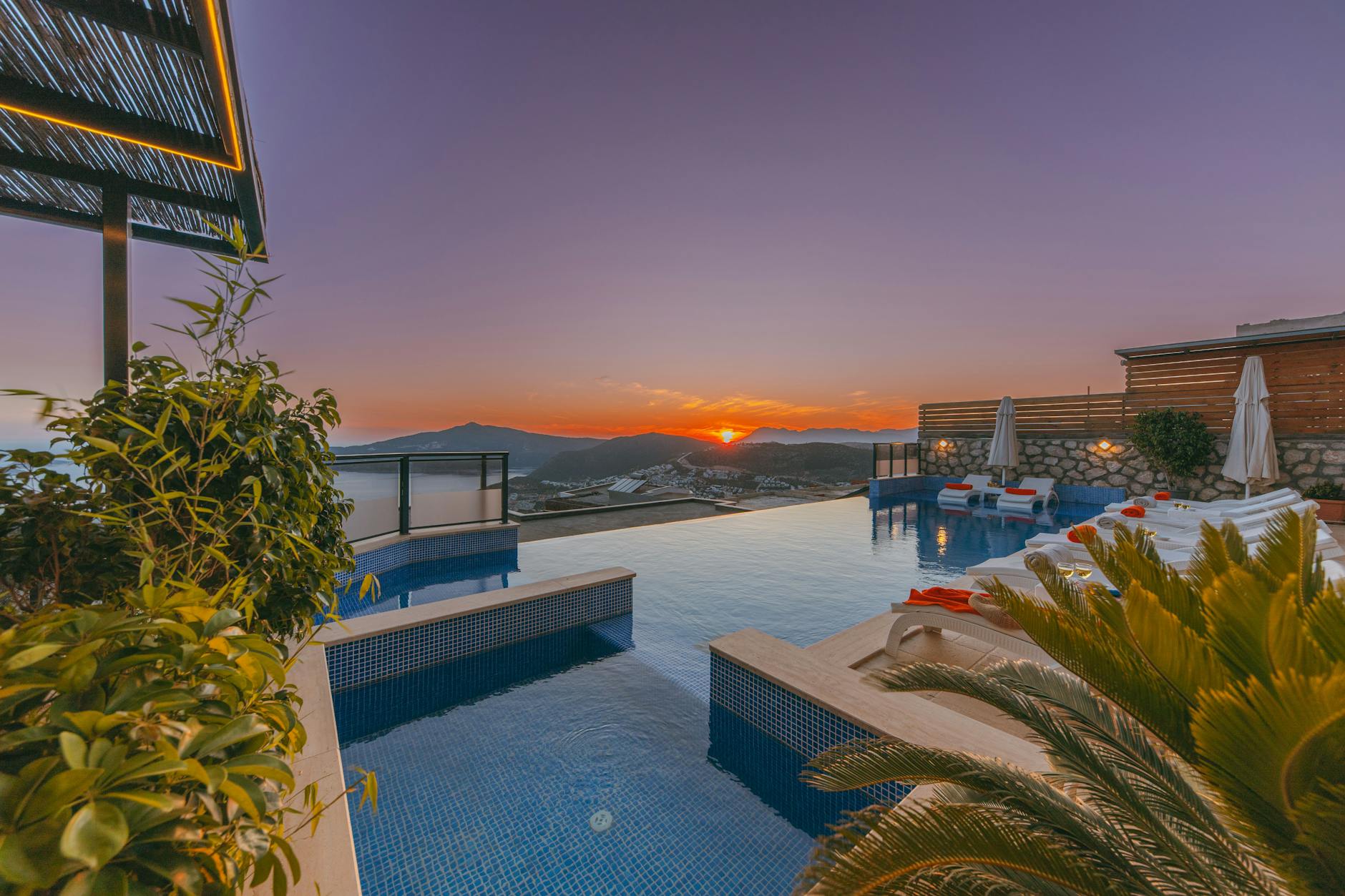 Luxury hotel suite with an infinity pool at sunset