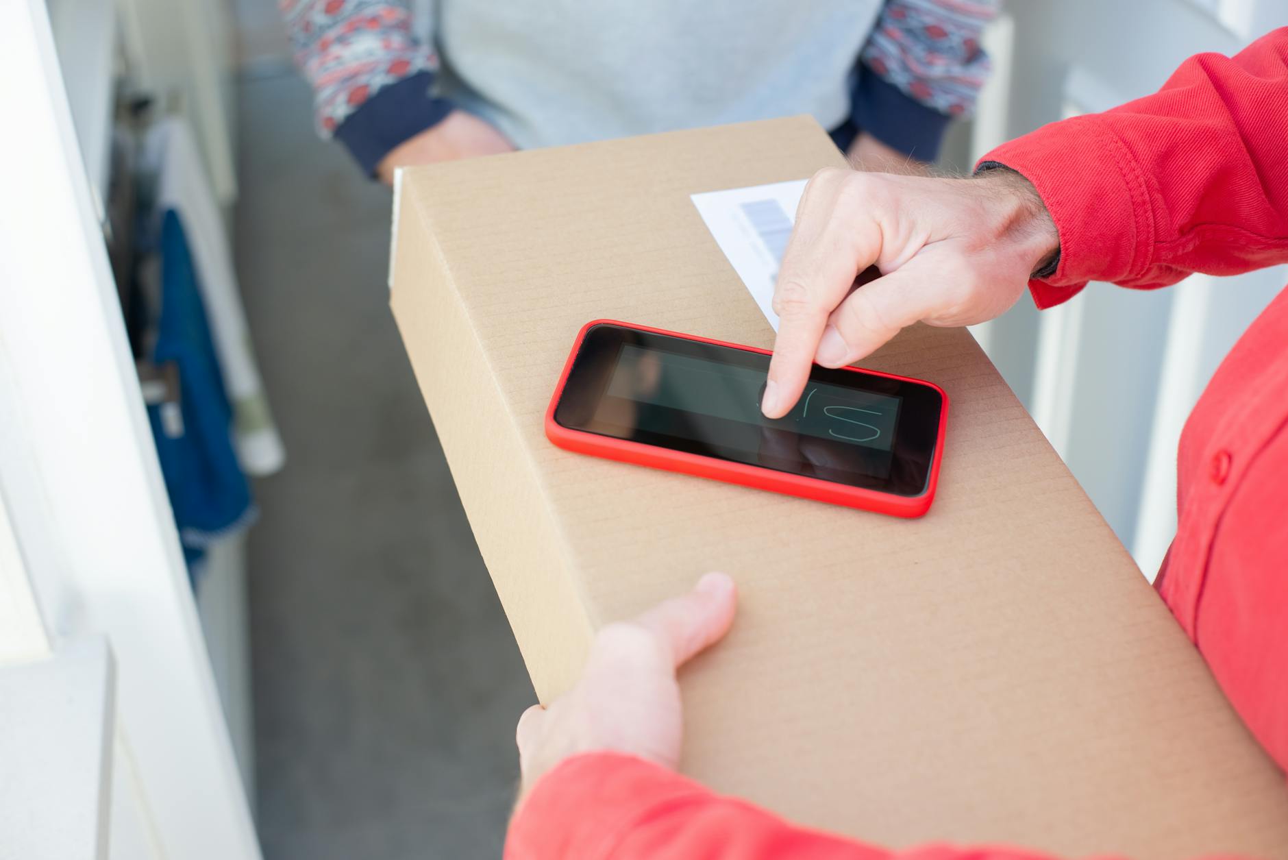 Online shopping smartphone next to parcels at the doorstep