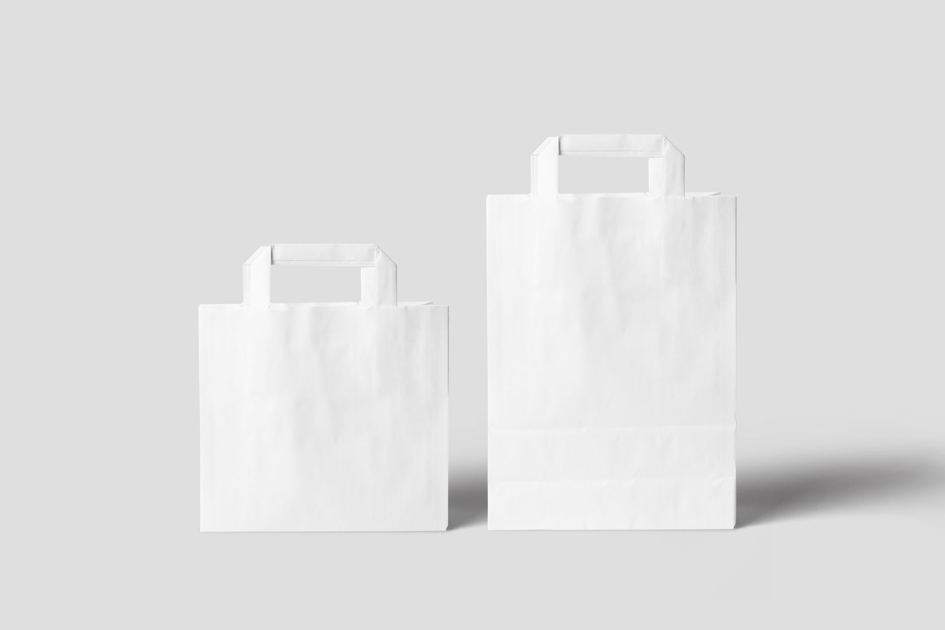Paper shopping bags on a plain background