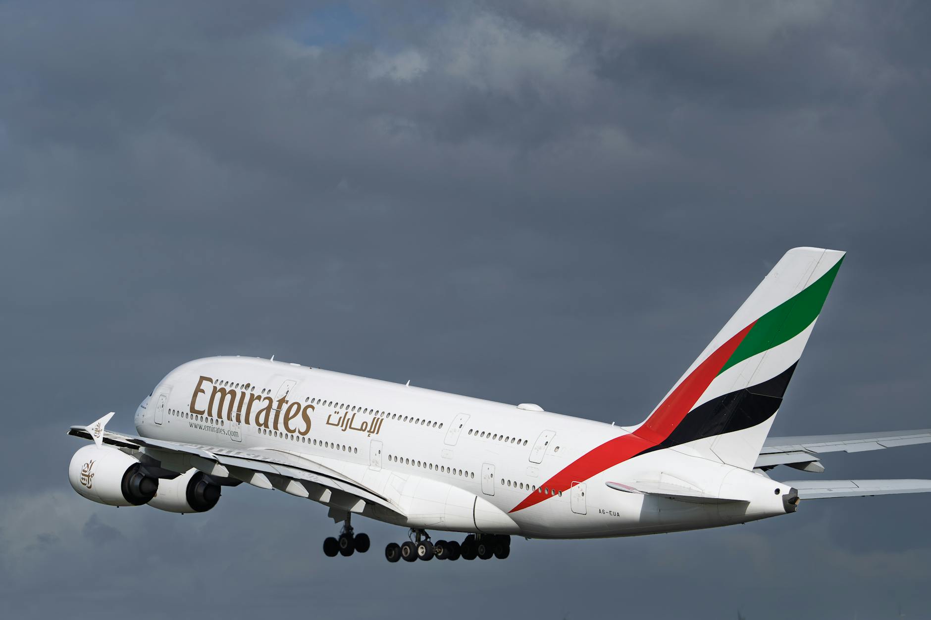 Emirates A380 climbing out under overcast sky