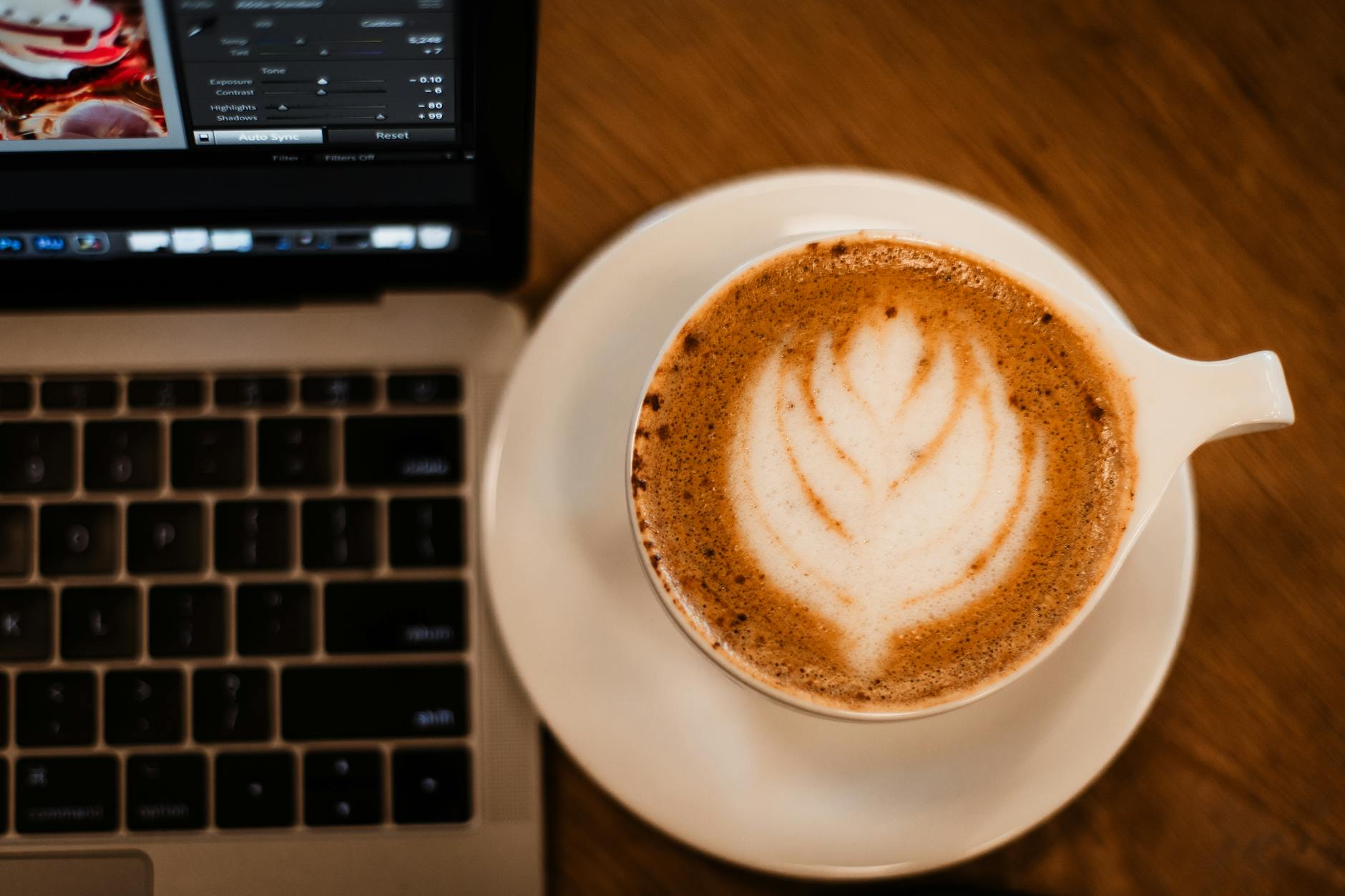 Dubai cafe morning latte and laptop on a marble counter