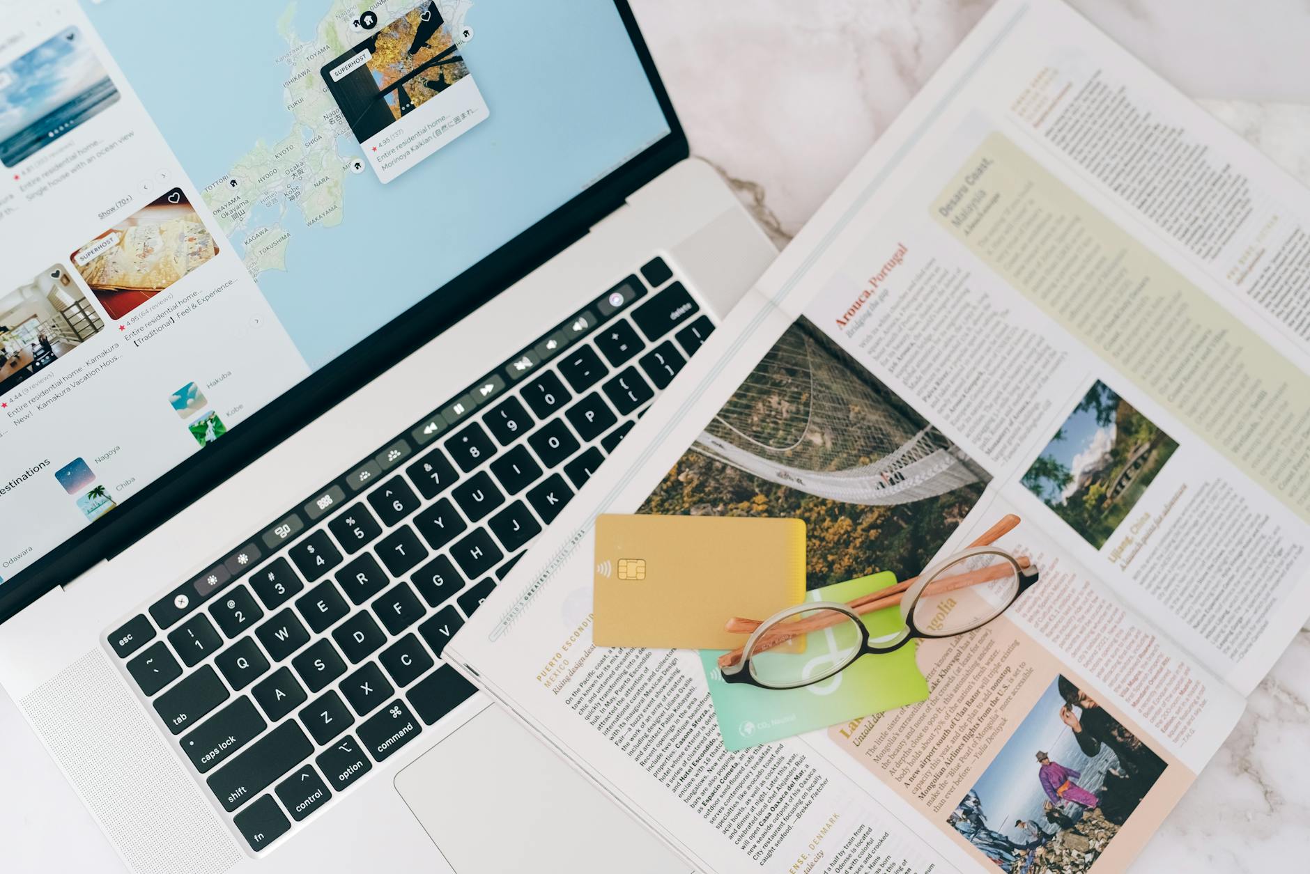 Hands booking a holiday online via a laptop travel portal