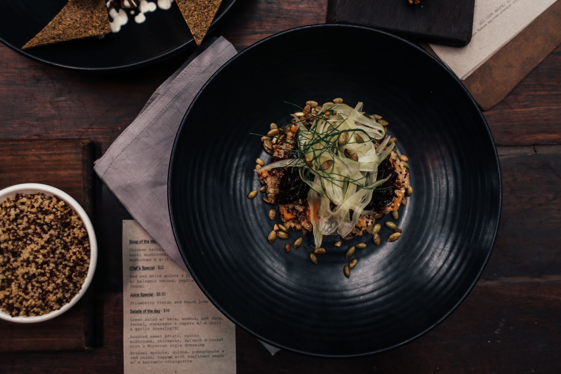 Plates of food laid out on a restaurant table, seen from above
