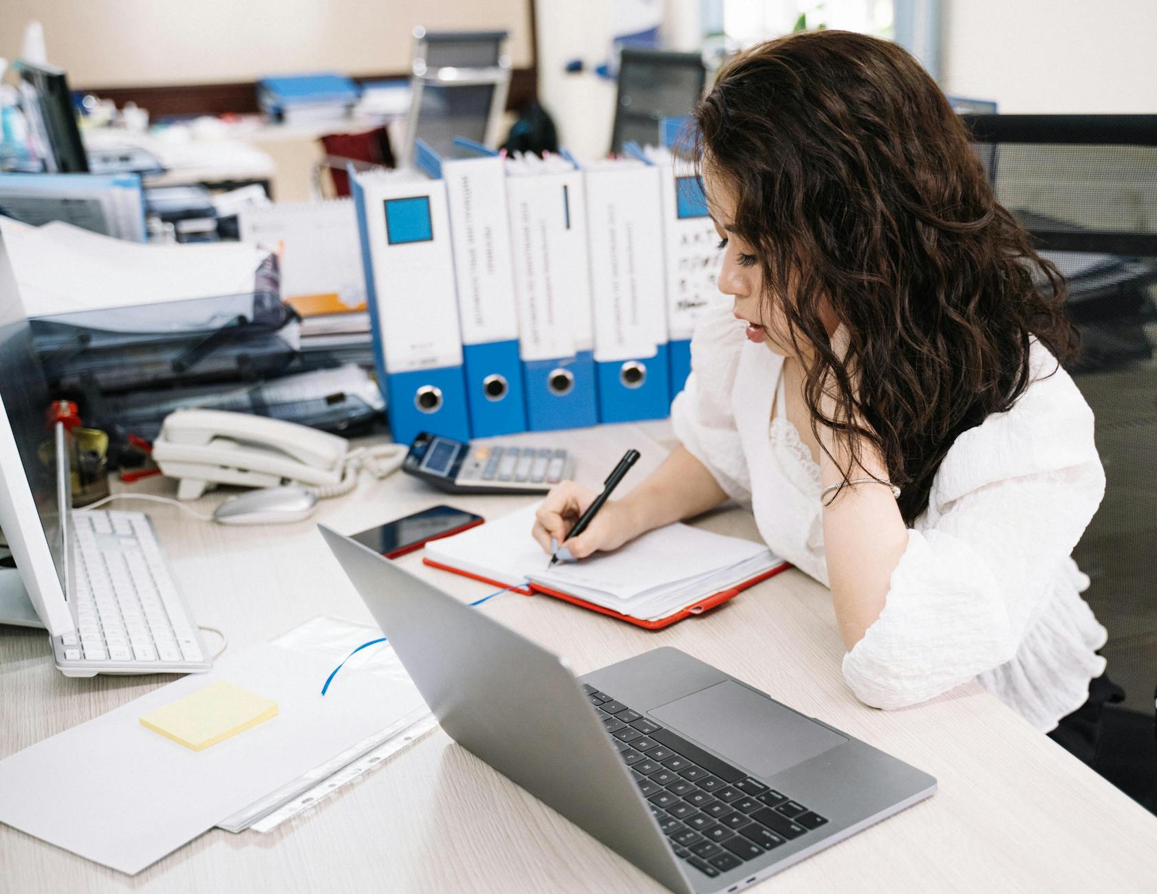 Office desk in Dubai with laptop and paperwork