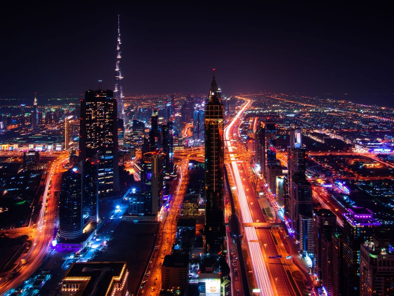 Dubai from the air at night, Sheikh Zayed Road and the downtown towers lit up