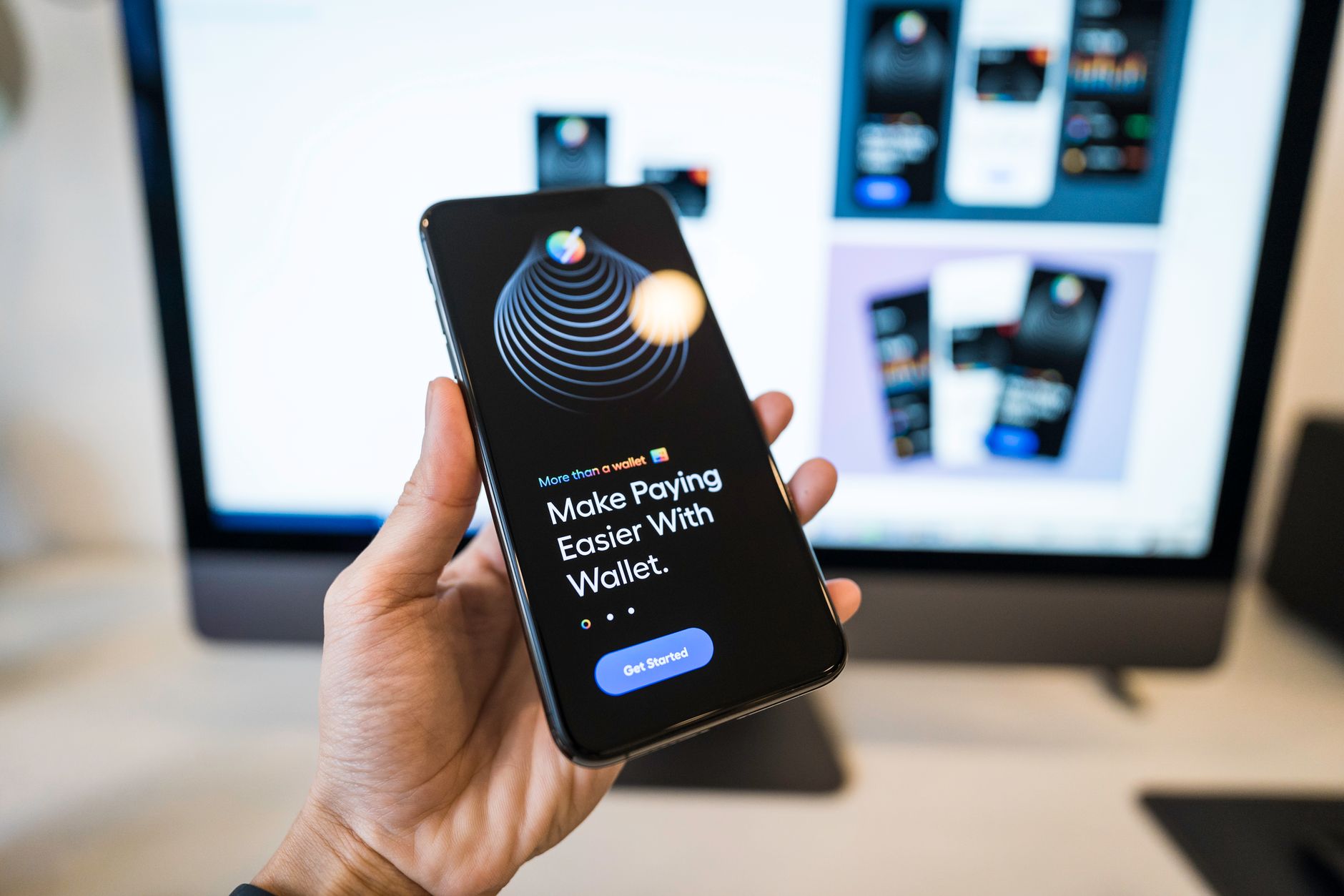 Hand holding a phone showing a banking app