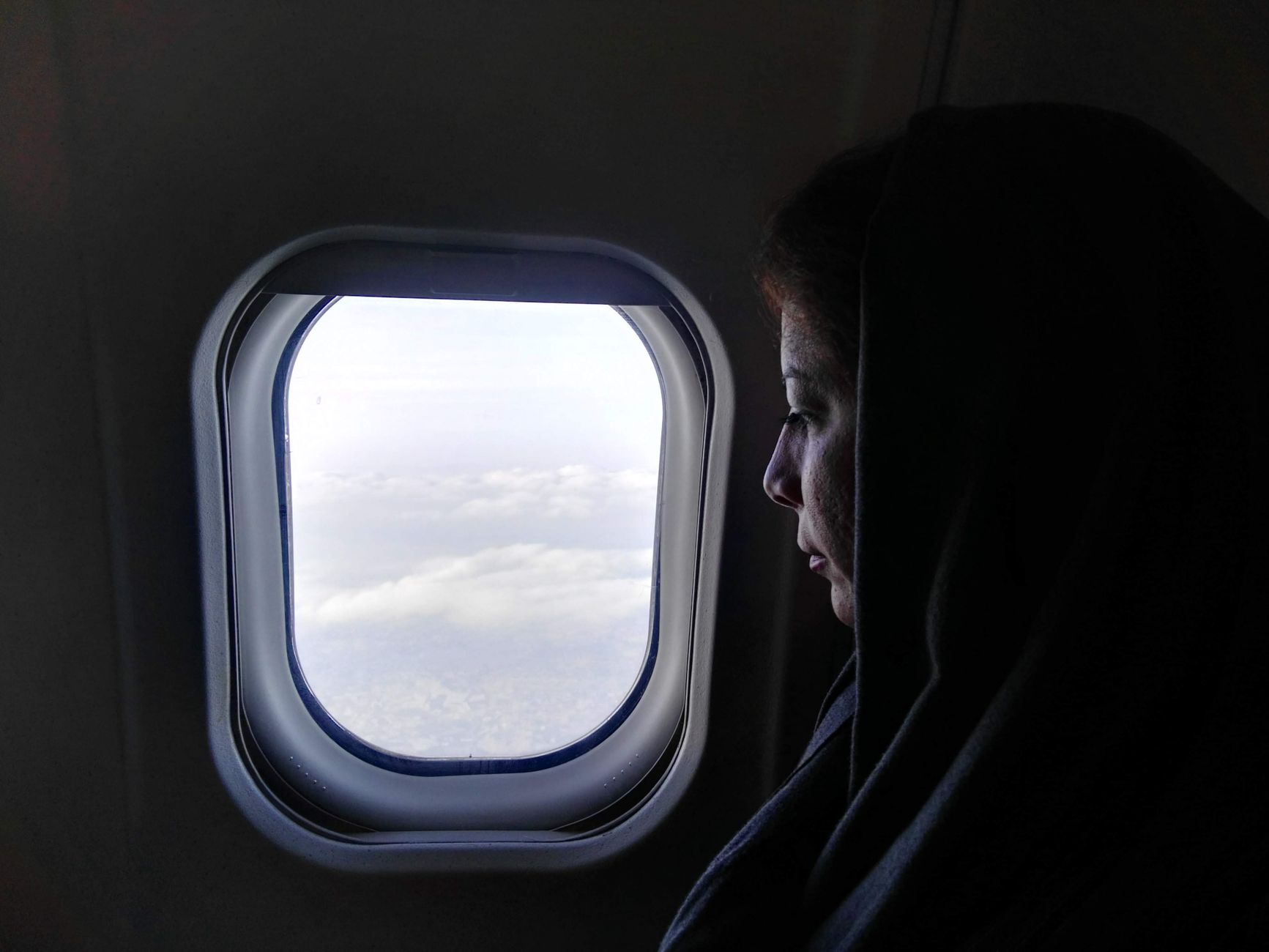 The view of sky and cloud through an aircraft window, illustrating a cabin product story.