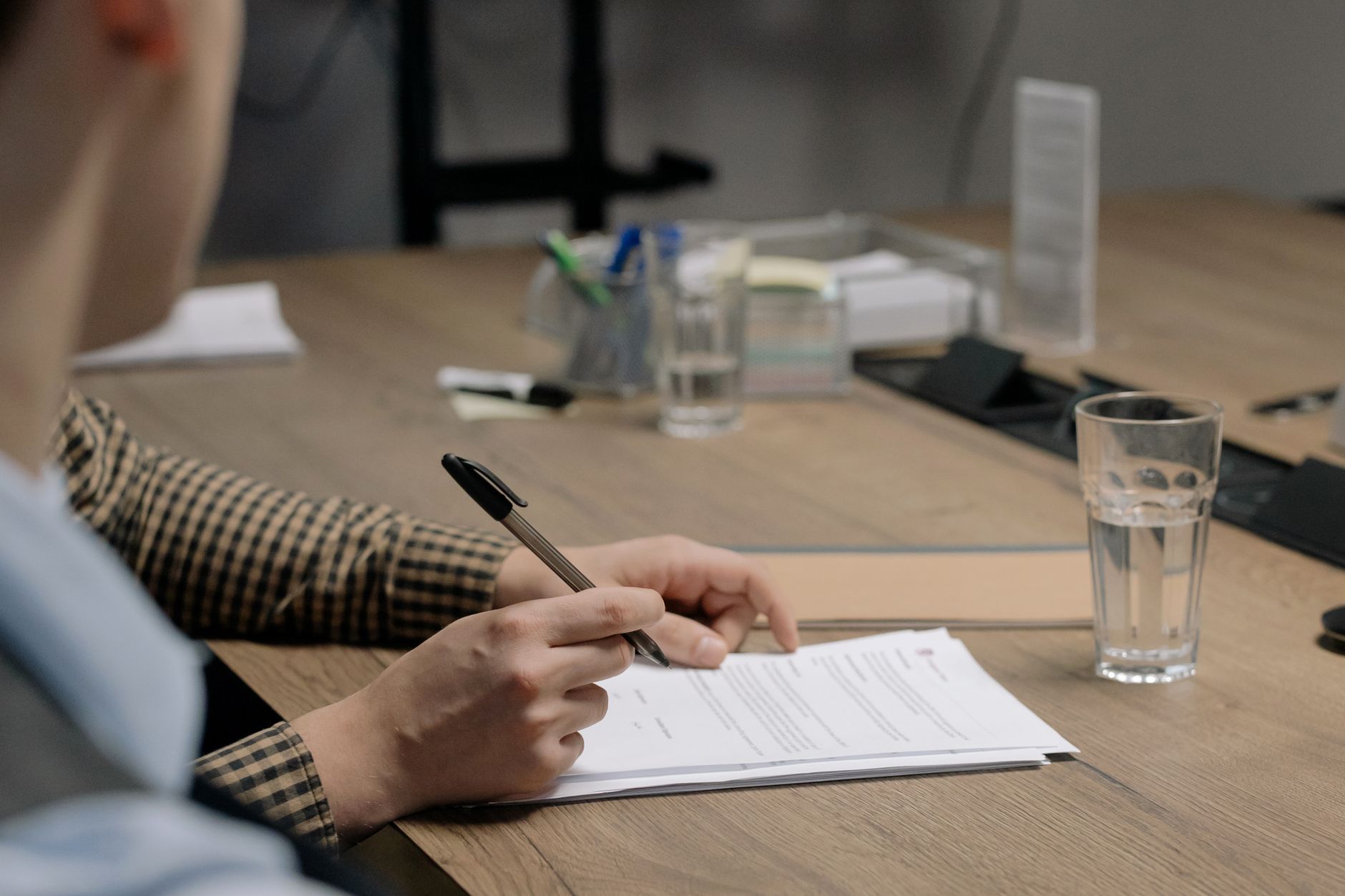 Signing paperwork at an office desk