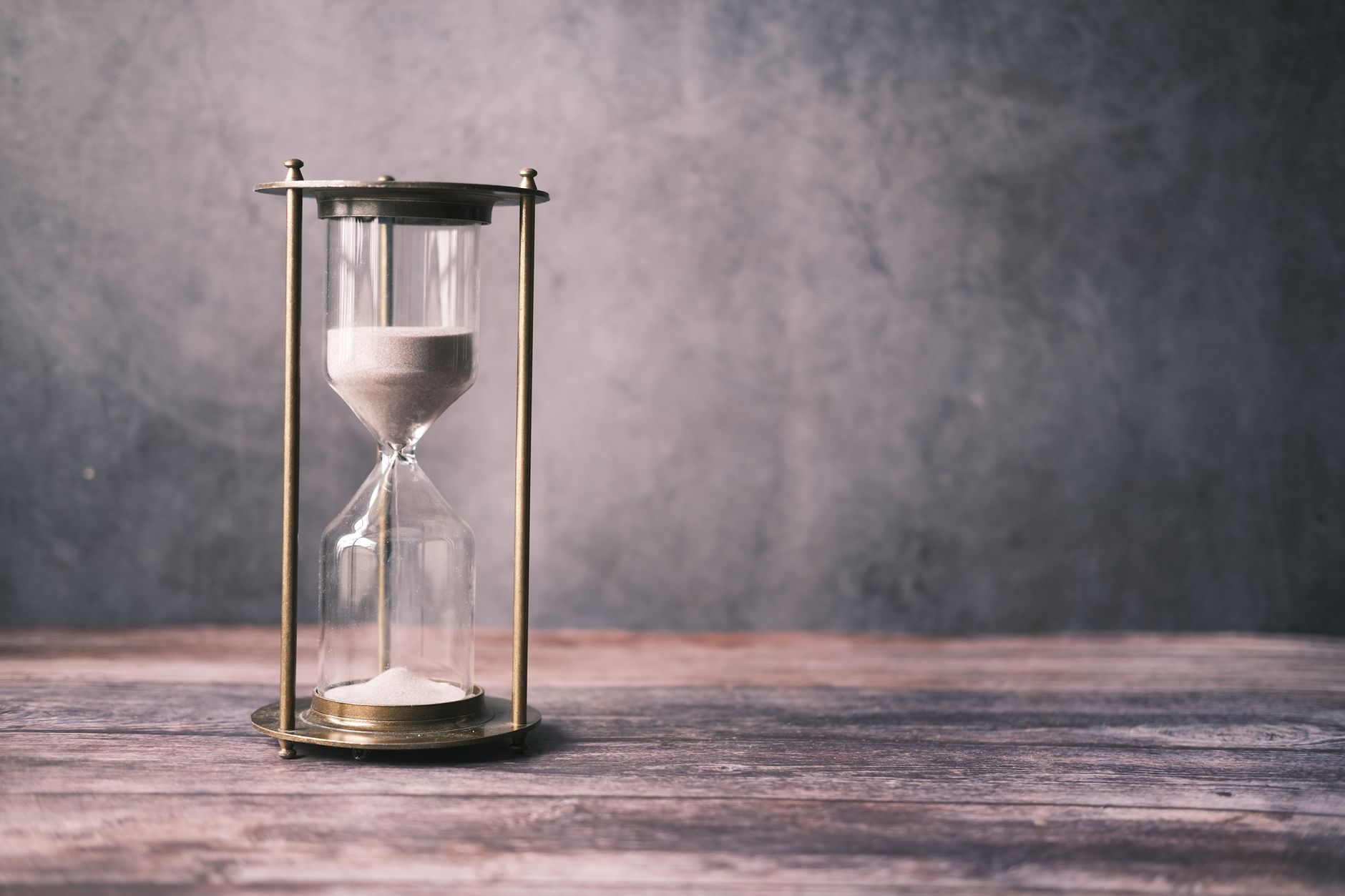 Hourglass running down on a table