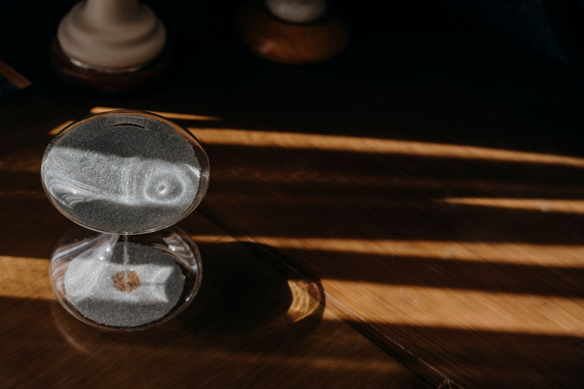 An hourglass on a warm wooden surface, illustrating a change to how long loyalty points remain valid.
